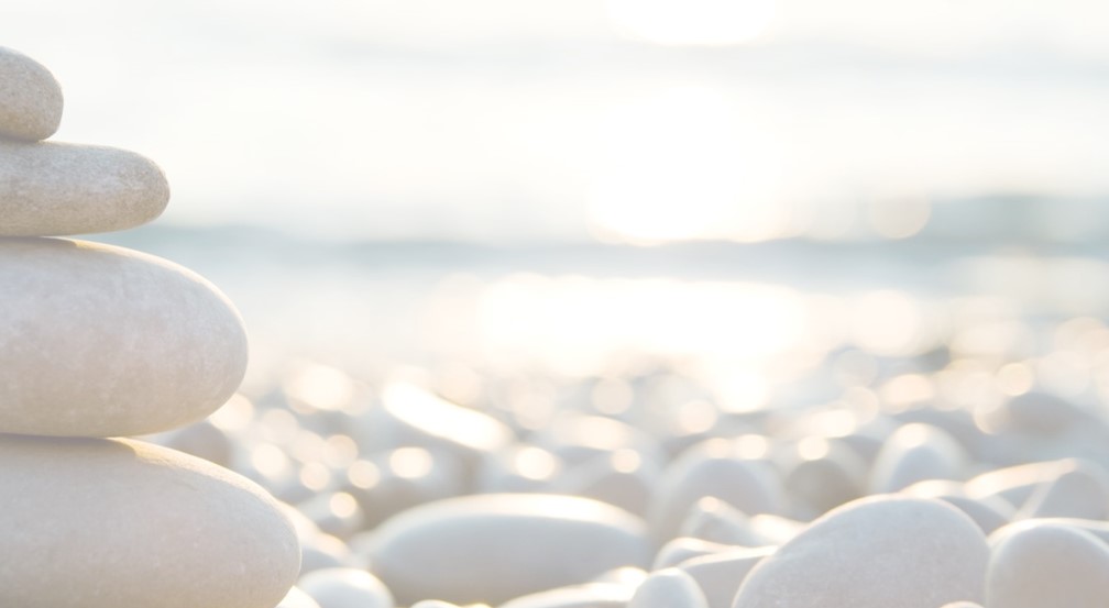 Smooth pale pebbles stacked by the sea